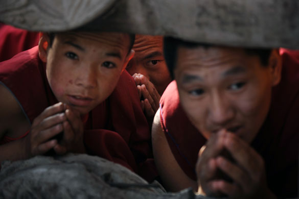 24 hours in pictures: Bodhgaya, India: Buddhist monks try to catch a glimpse of The Dalai Lama
