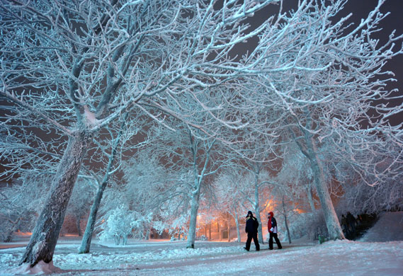 24 hours in pictures: Oberhof, Germany: Pedestrians in the illuminated Kurpark