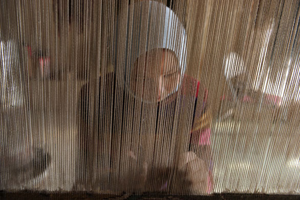 24 hours in pictures: Kabul, Afghanistan: Sixteen-year-old Saliha weaves carpet in her home