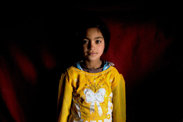 24 hours in pictures: Kabul, Afghanistan: An internally displaced girl inside a derelict hut