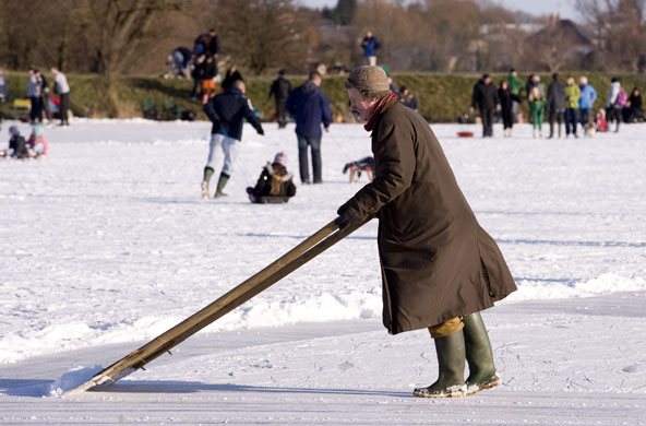Skating on the fens: Clearing away the loose snow to make a smoother surface to race on