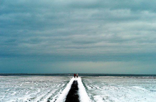 24 hours in pictures: Westerhever, Germany: People stroll on an icy mudflat  