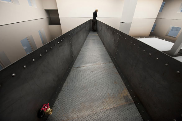 Richard Wilson 20:50: A visitor looks at 20:50, containing 8,000 litres of recycled engine oil