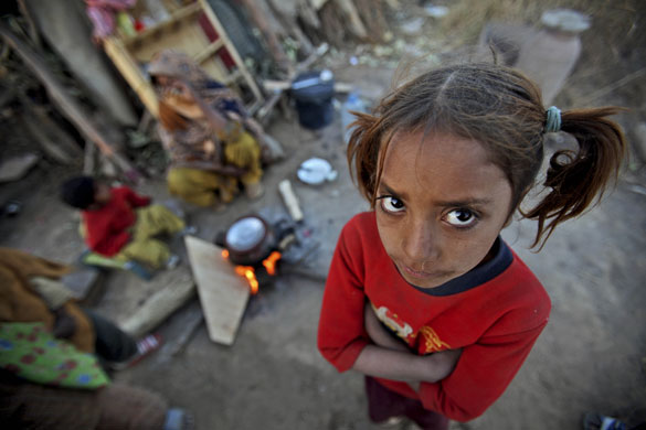 24 hours in pictures: Islamabad, Pakistan: A girl stands next to her mother
