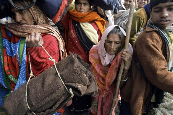 24 hours in pictures: Harwood Point, India: Hindu pilgrims wait on a jetty 
