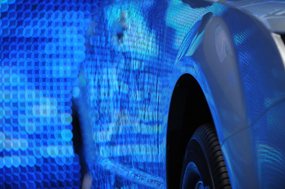 Green cars in Detroit: Background lights reflect off the Chinese BYD E6 electric car