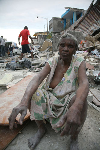 Haiti earthquake: A woman sits amid  in Port-au-Prince