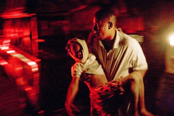 Haiti earthquake: A man carries an injured child  in Port-au-Prince 