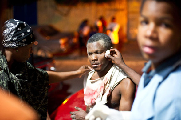 haiti update: Major Earthquake Hits Haiti People come to the aid of a wounded man