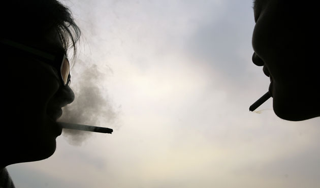 24 hours: Pingtung, Taiwain: Two men smoke on a university campus 