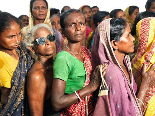 Sinking Sundarbans: Women stand in a queue to receive emergency relief supplies