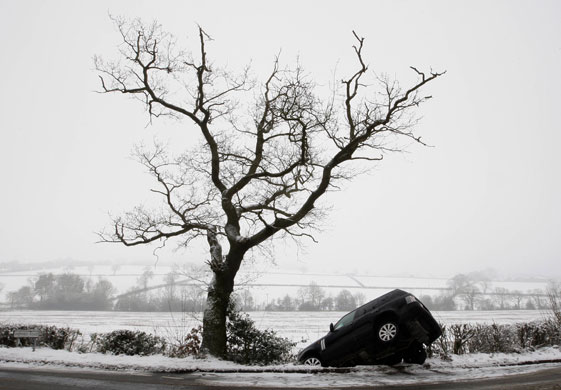 Snowing again: A Range Rover lies in a ditch after leaving an icy road in Ulverscroft