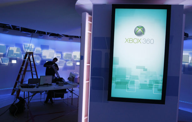 Week in Business: A worker sets up at the Microsoft booth at CES in Las Vegas