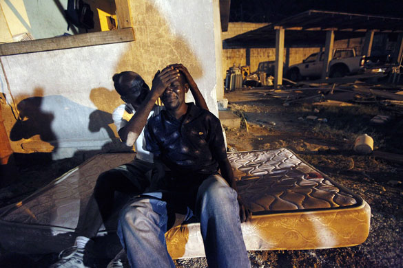 24 hours in pictures: Port-au-Prince, Haiti: Gunsly Milsoit, left, comforts his brother-in-law