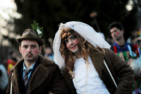 24 hours in pictures: Elovdol, Bulgaria: Men dressed as a newly-married couple attend a carnival
