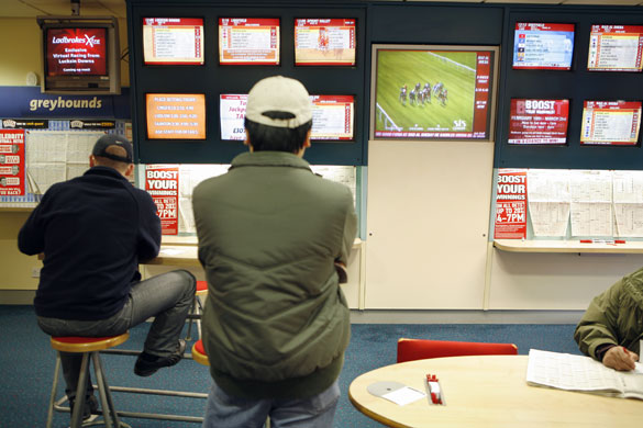 Week in Business: Punters watch a horse race in a Ladbrokes betting shop in Nottingham