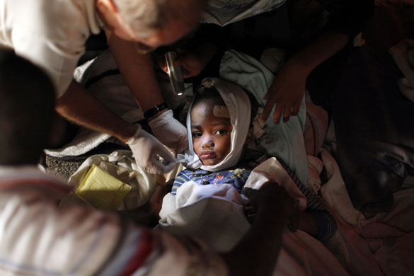 History of Haiti: An injured child is treated after an earthquake in Port-au-Prince