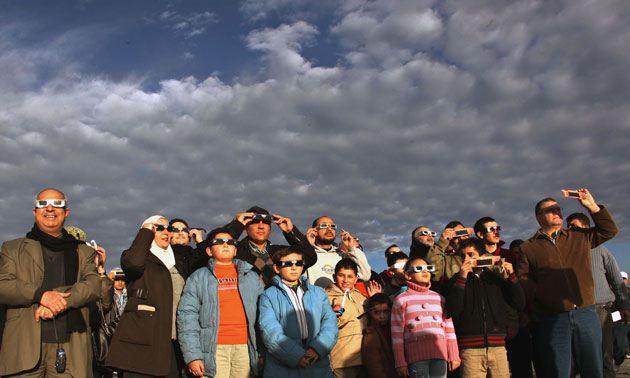 solar eclipse: Residents watch a solar eclipse in Amman, Jordan
