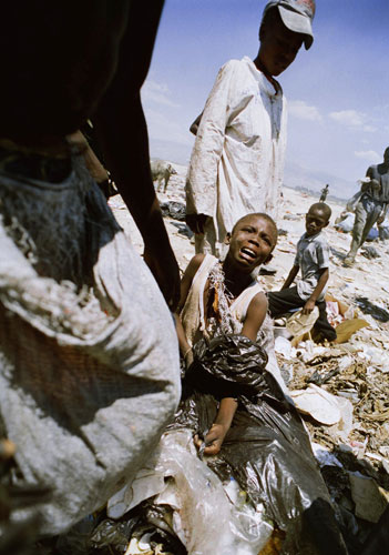 History of Haiti: 1995: A girl cries after someone stole the rubbish she had scavenged