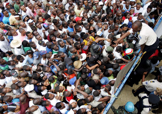 History of Haiti: 2006: A Haitian policeman tries to calm a crowd entering a polling station