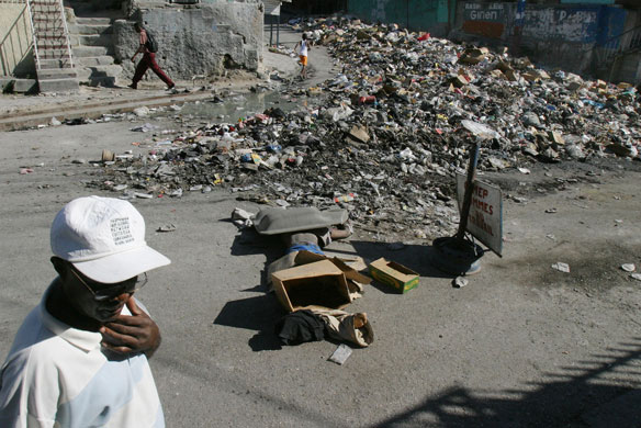 History of Haiti: 2004: The body of a young man lies on the pavement in Bel-Air