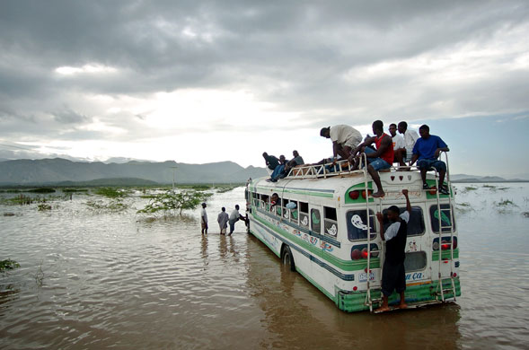 History of Haiti: 2004: A bus filled with Haitian people makes its way on a flooded road