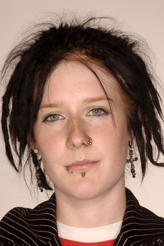Teenage Hair: A teenage girl with messy hair & facial piercings