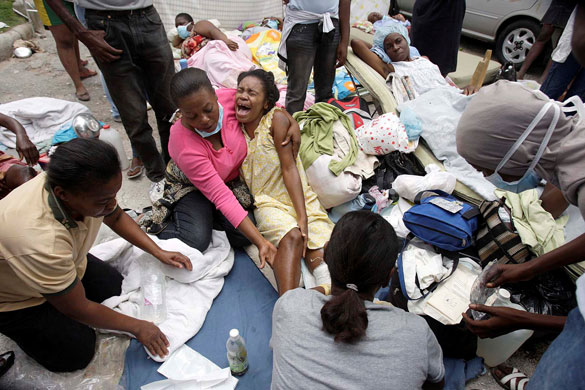 Rescue efforts in Haiti: A woman is treated for her wounds on the grounds of Canape-Vert Hospital