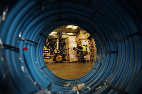 Rescue efforts in Haiti: A fork lift truck driver loads water sanitation equipment at Oxfam
