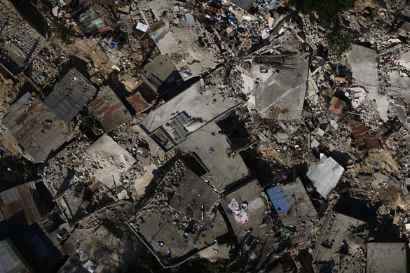 24 Hours in Pictures: Homes lays in ruins due to an earthquake in Port-au-Prince