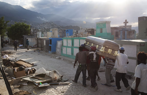 David Levene in Haiti: A coffin containing a victim is brought to the cemetery in Port-Au-Prince