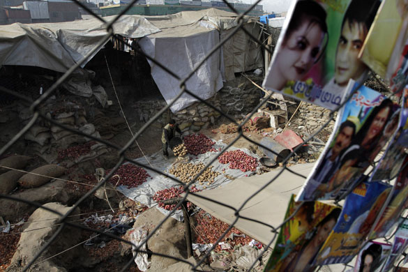 24 hours: Kabul, Afghanistan: An Afghan vendor sorts potatoes
