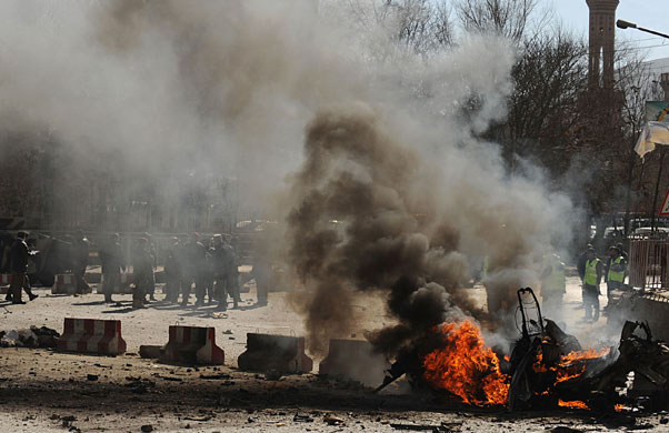 Kabul violence: Afghan policemen secure the site of a second suicide attack in Kabul 