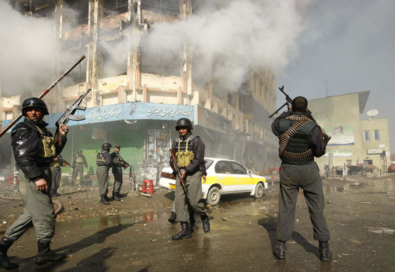 Kabul violence: Afghan policemen gather around a shopping mall 