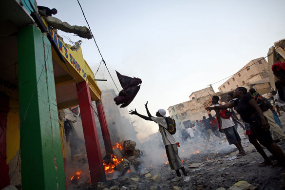 Lawless Haiti: People loot a a damaged store in Port-au-Prince
