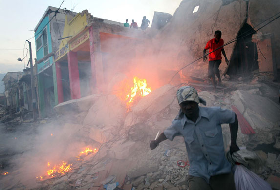 Lawless Haiti: Looters take what they can from a building destroyed in the earthquake