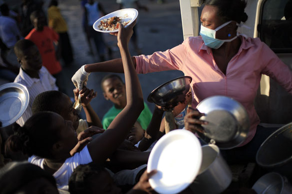 Lawless Haiti: People try to get food at a food distribution centre in Port-au-Prince 