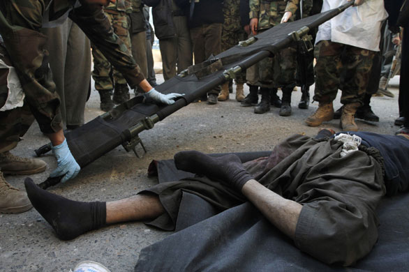 Violence in Kabul: Security personnel prepare to remove the body of a suicide attacker