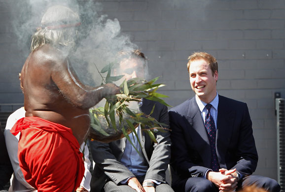Prince William down under: Prince William laughs as an Aboriginal elder wafts smoke in his face