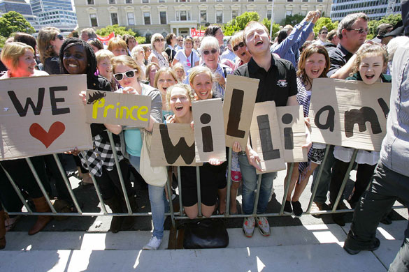 Prince William down under: People hold placards as they wait for Prince William to arrive