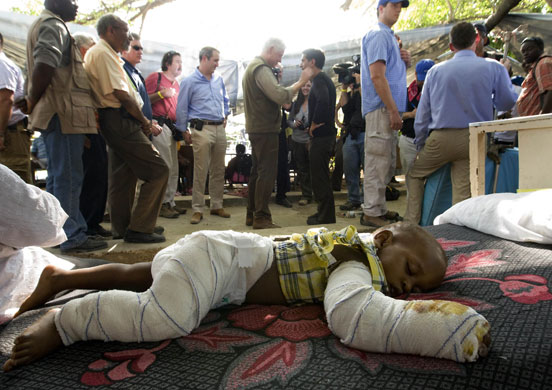 Haiti Aid: Bill Clinton (centre) gives an interview