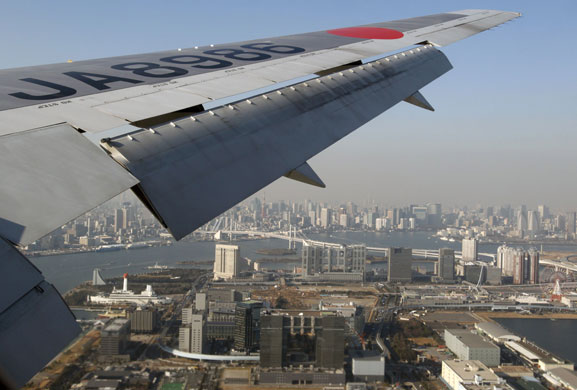Japan Airlines: January 2010: A Japan Airlines plane flies over Tokyo