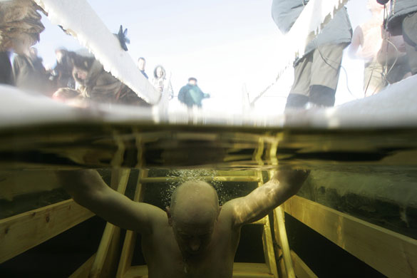 Orthodox Epiphany : A man dips into the icy waters of the Moskva River