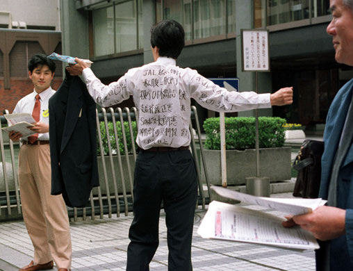 Japan Airlines: One of Japan Airlines' shareholders displays a shirt 