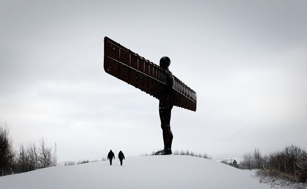 24 Hours: People are seen walking past the Angel of the North in heavy snow