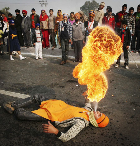 24 Hours: A Sikh performs a fire stunt during a religious procession in Jammu
