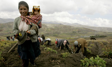 A farmer walks with her son in Peru