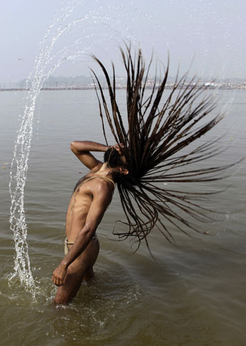 24 hours in pictures: Allahabad, India: A Hindu holy man takes a dip at Sangam
