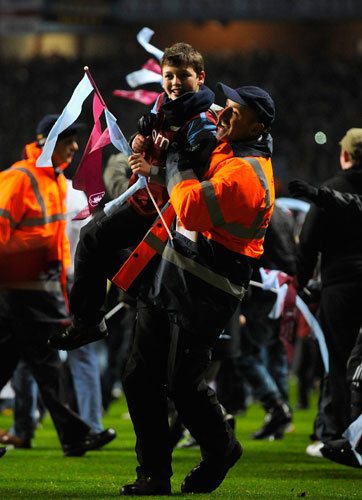Wednesday Football: Young Aston Villa fan is escorted off the pitch
