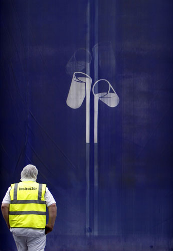 Week in Business: A worker enters the Cadbury factory in Bournville.